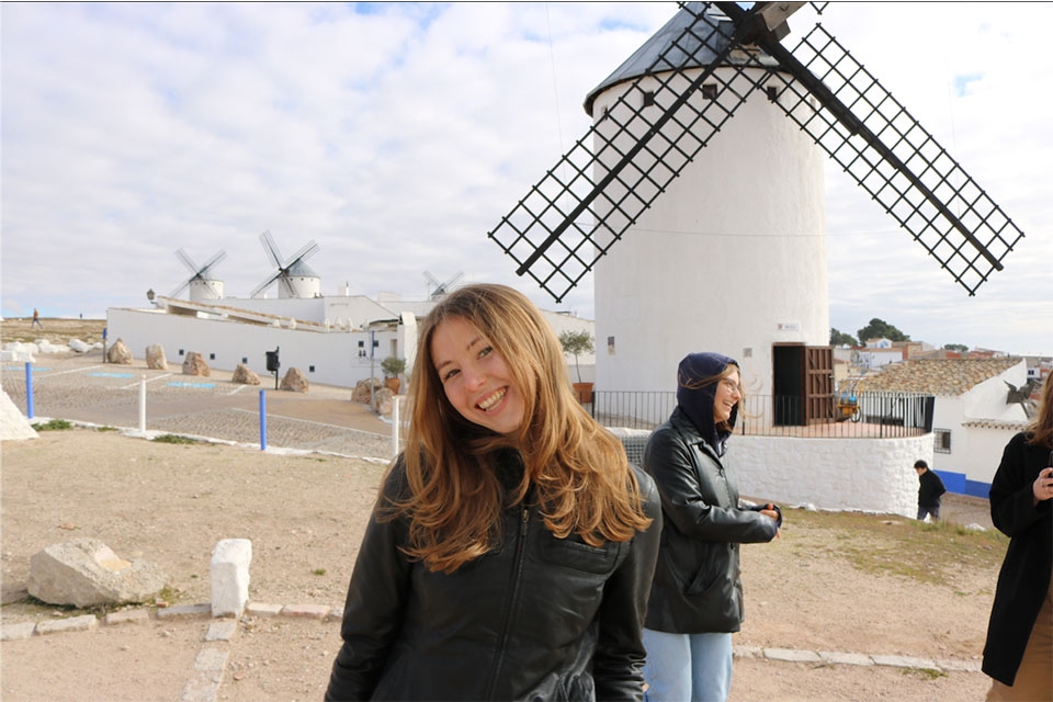 Isabella Banks poses in Spain with windmills in the background