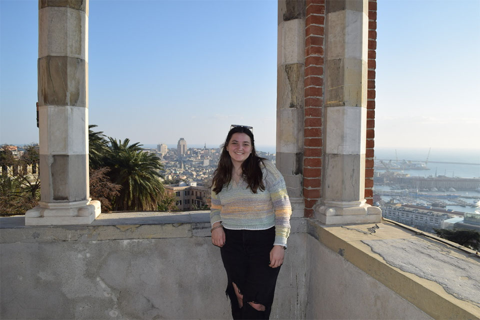 Emma Schmidt in Ireland at an observatory overlooking a city backdrop with clear blue skies