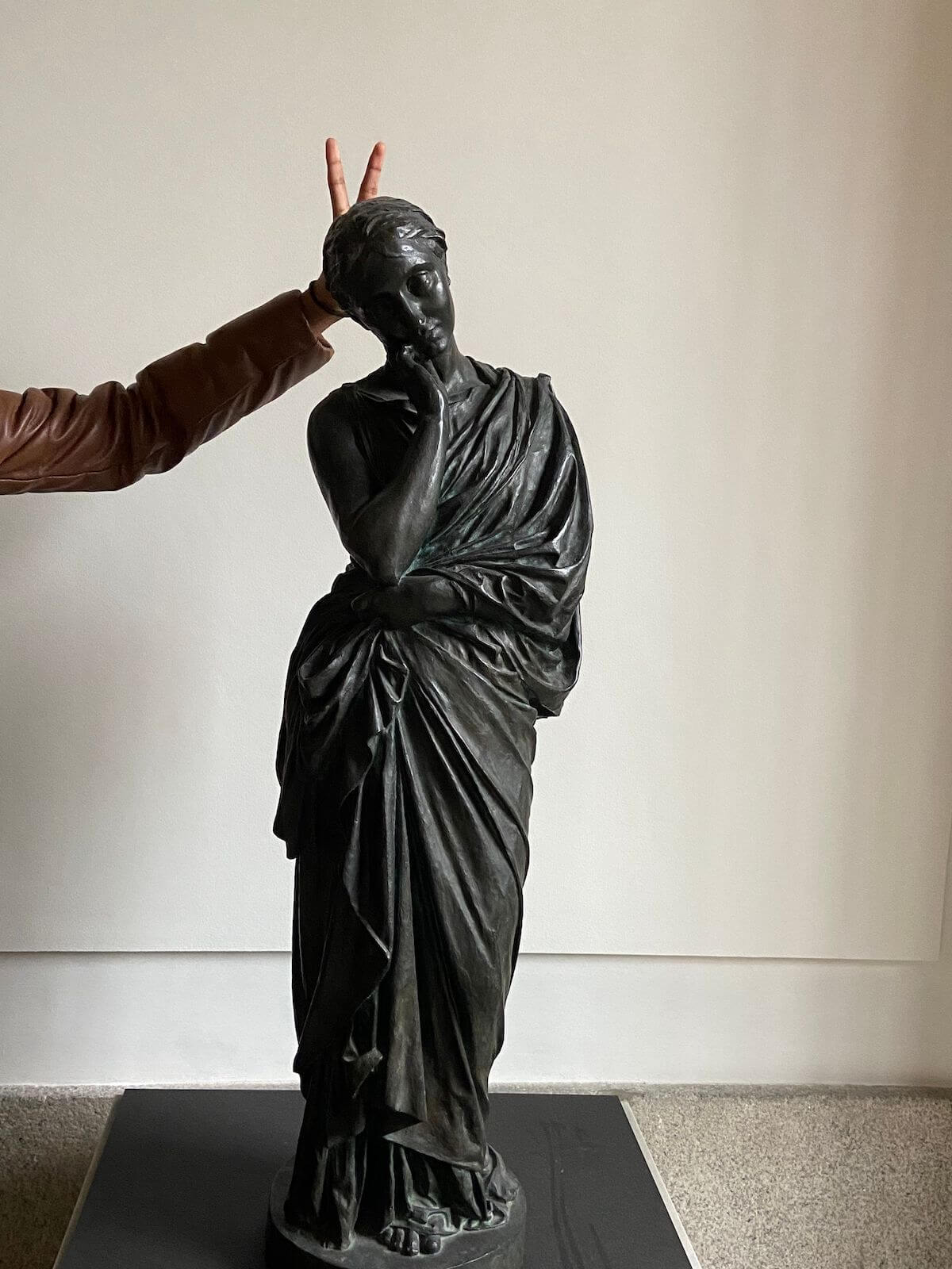 a fun photo giving bunny ears to a statue