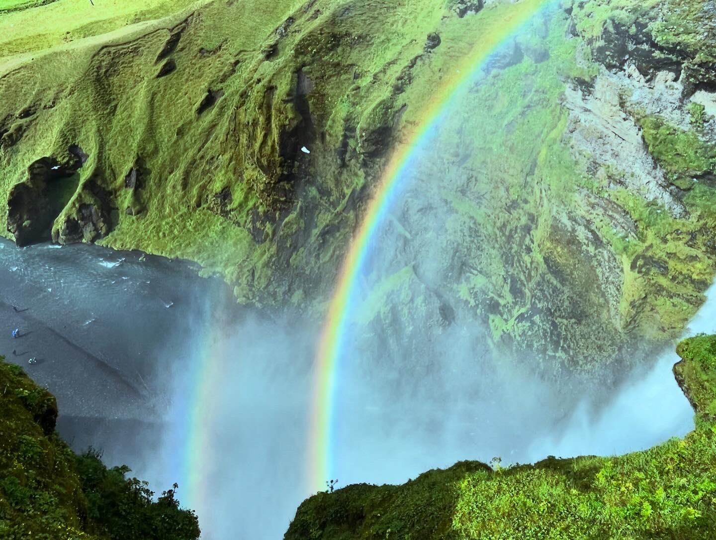 view of a rainbow on a waterfall in Iceland