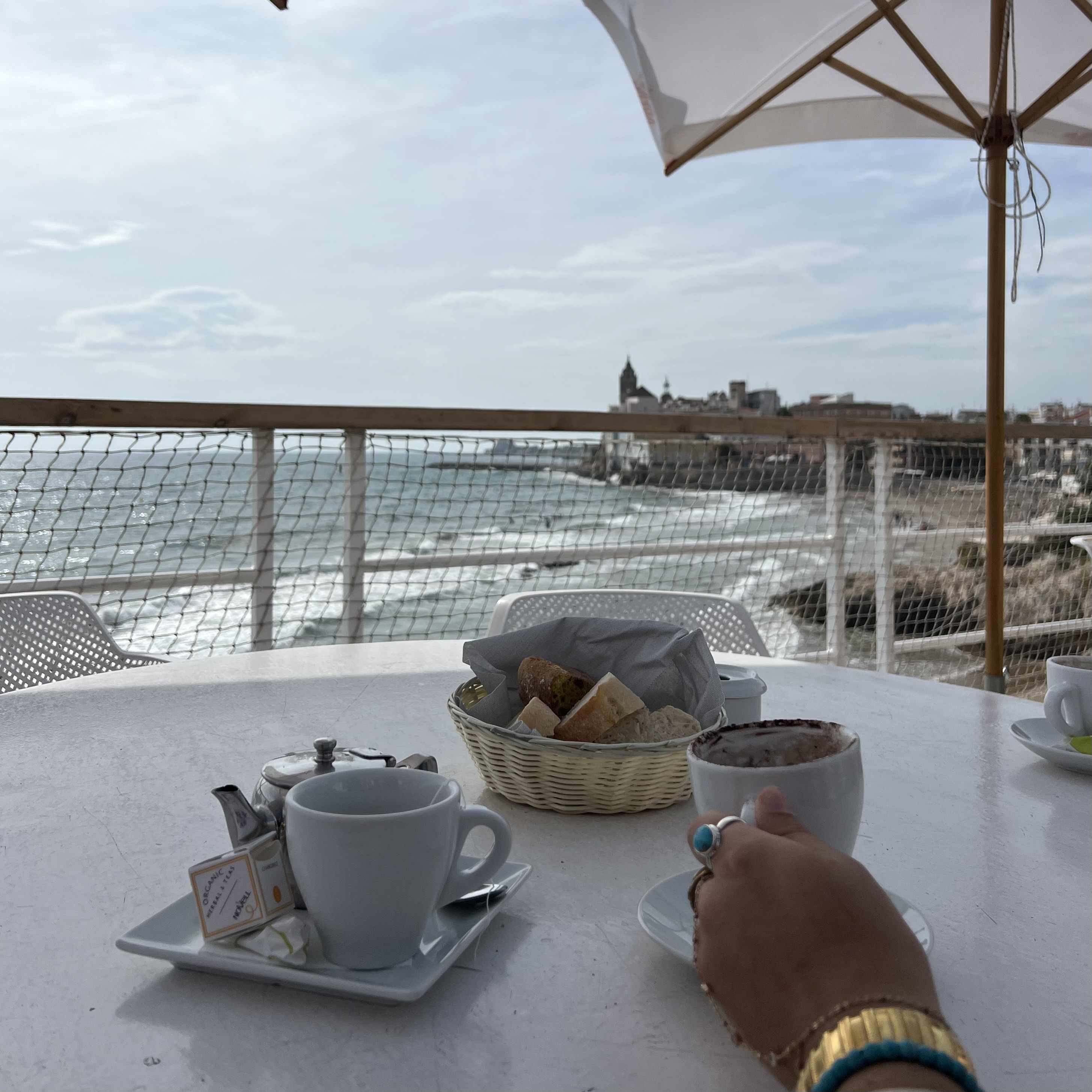 student enjoying a cup of coffee with view of the ocean