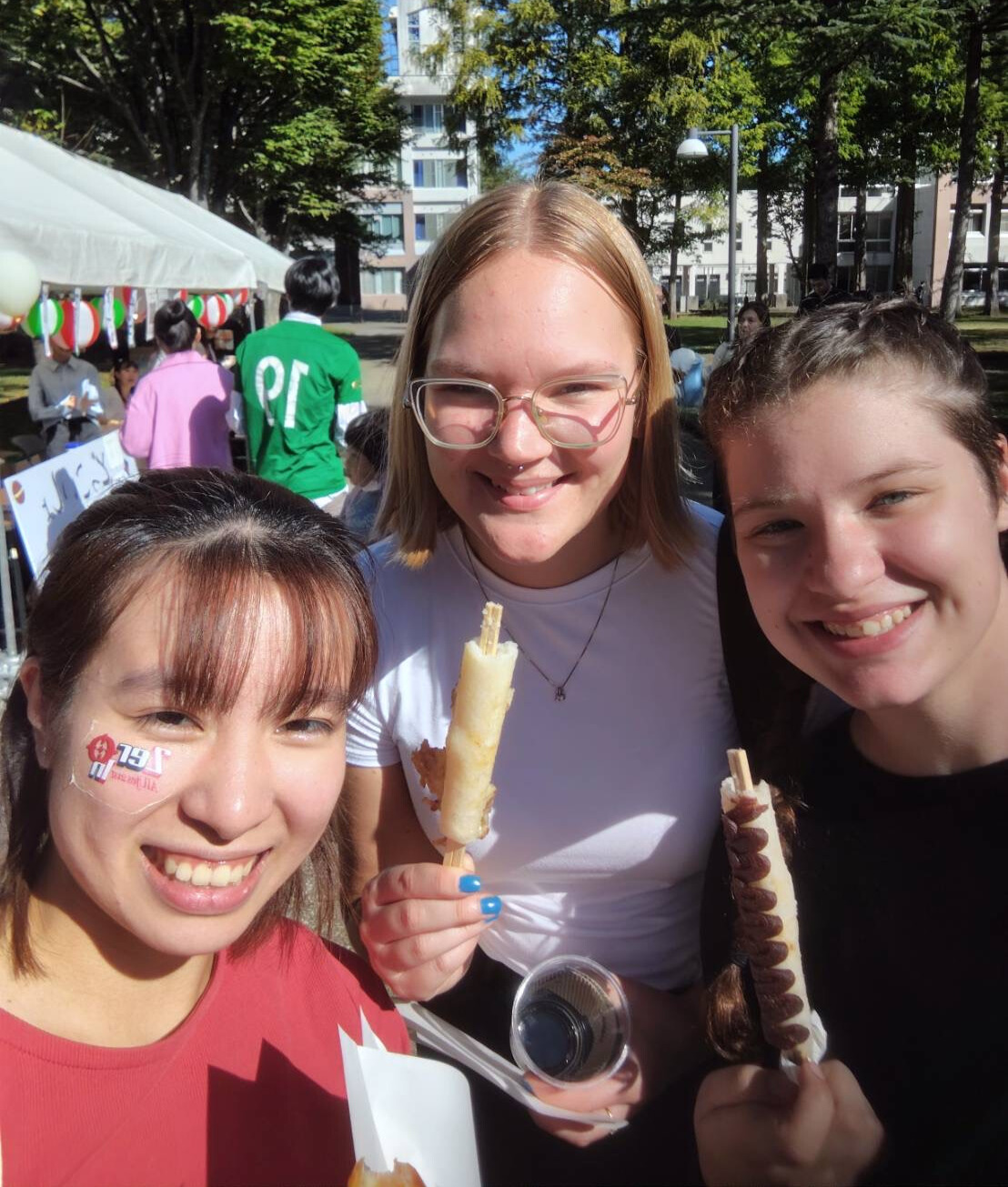 picture of Claude and friends eating some yummy food from the food stalls at the school festival 