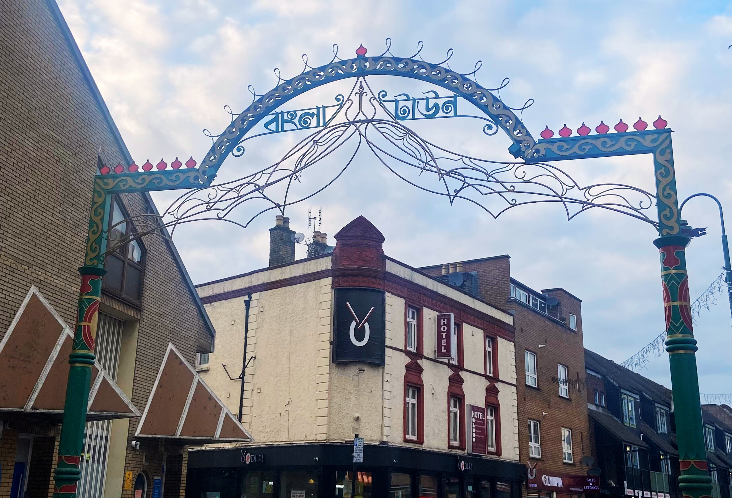 student walking through Brick Lane in London, England
