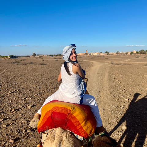 student riding a camel in Morocco