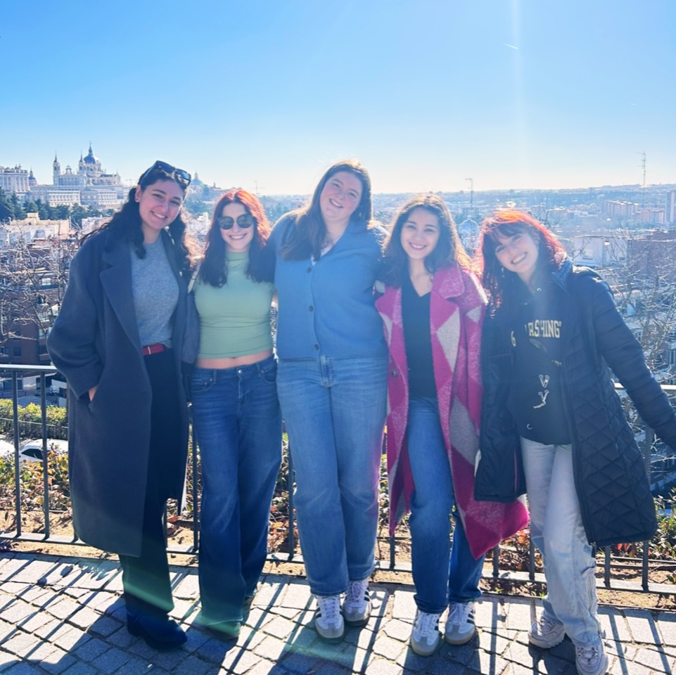 student with group of friends with view of the city behind them