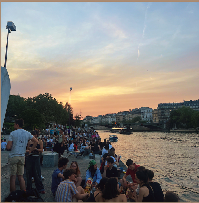people enjoying the sunset by the canal in Paris 