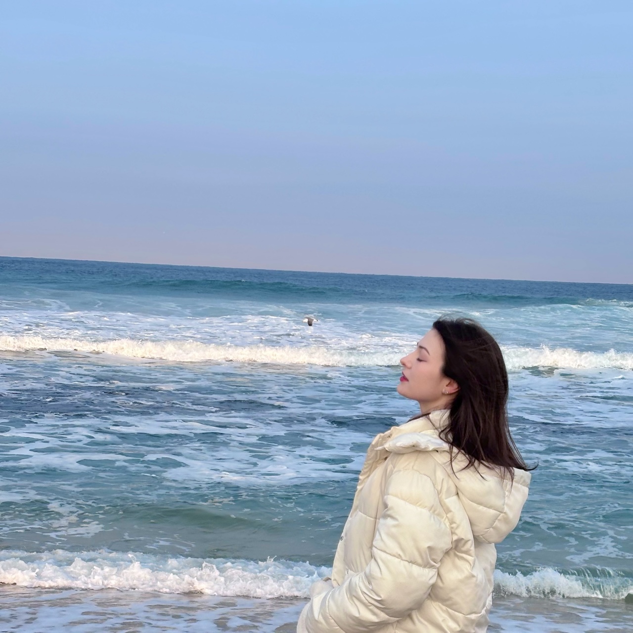 student posing in front of a beach in Gangneung