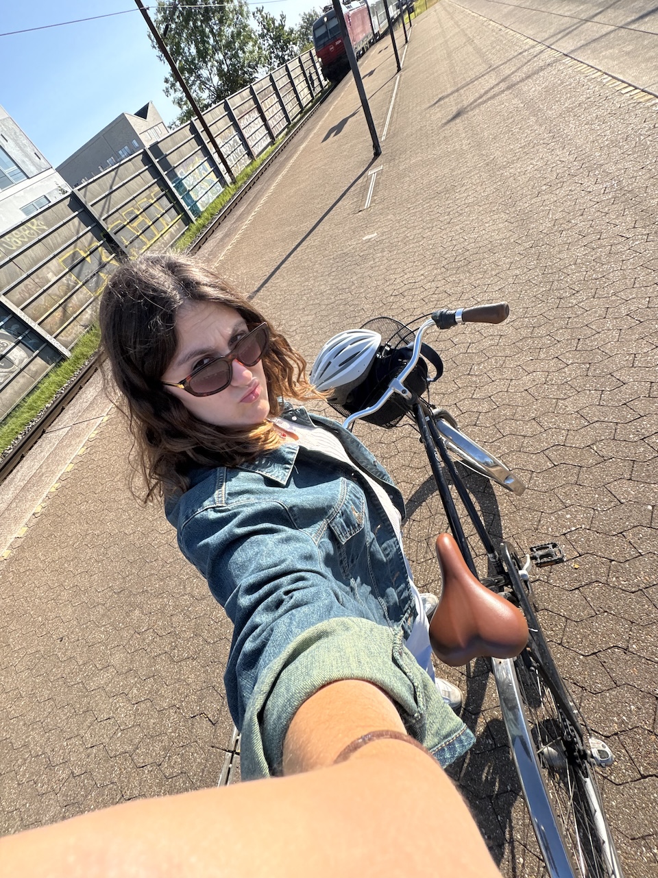 student taking a selfie as they bike in Copenhagen