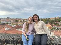 Madeline Lucy Pfeiffer and a friend sitting on a stone wall in France
