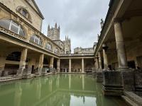 Photo of an old stone building in London with green water in the middle