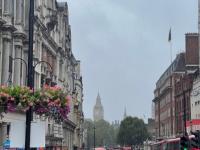 A foggy. rainy day in London with city buildings and Big Ben seen in the background