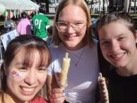 picture of Claude and friends eating some yummy food from the food stalls at the school festival 