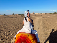 student riding a camel in Morocco