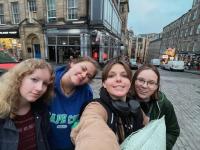 student taking a selfie with their groups of friends