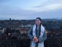 picture of student with the city Edinburgh in the background