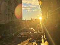 student took a picture of the sunset peeking through some buildings in Madrid