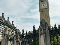 view of Big Ben Clock Tower and someone playing the bag pipes