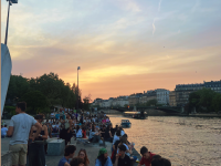 people enjoying the sunset by the canal in Paris 