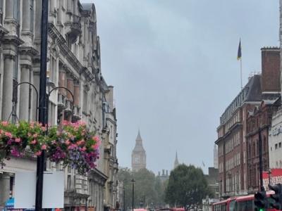 A foggy. rainy day in London with city buildings and Big Ben seen in the background