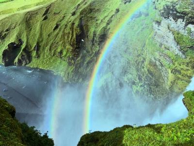 view of a rainbow on a waterfall in Iceland