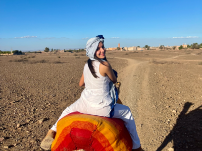student riding a camel in Morocco