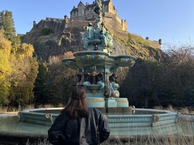 student standing in front of the water fountain at Edinburgh Castle is a historic castle in Edinburgh, Scotland.