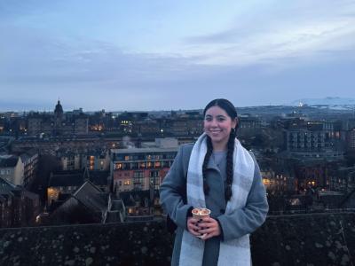 picture of student with the city Edinburgh in the background