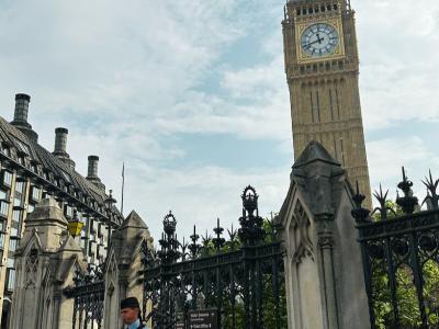 view of Big Ben Clock Tower and someone playing the bag pipes