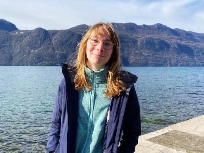student with the lake in France view and mountain range on the background