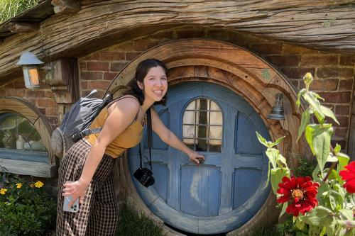 Dayani in front of a hobbit house in New Zealand