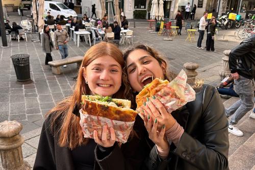 Alex and a friend enjoying food while travelling