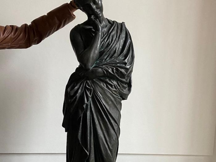 a fun photo giving bunny ears to a statue