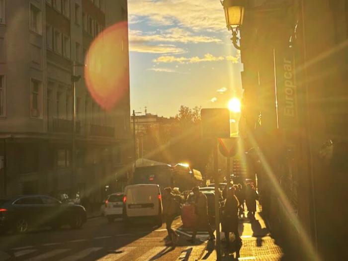 student took a picture of the sunset peeking through some buildings in Madrid