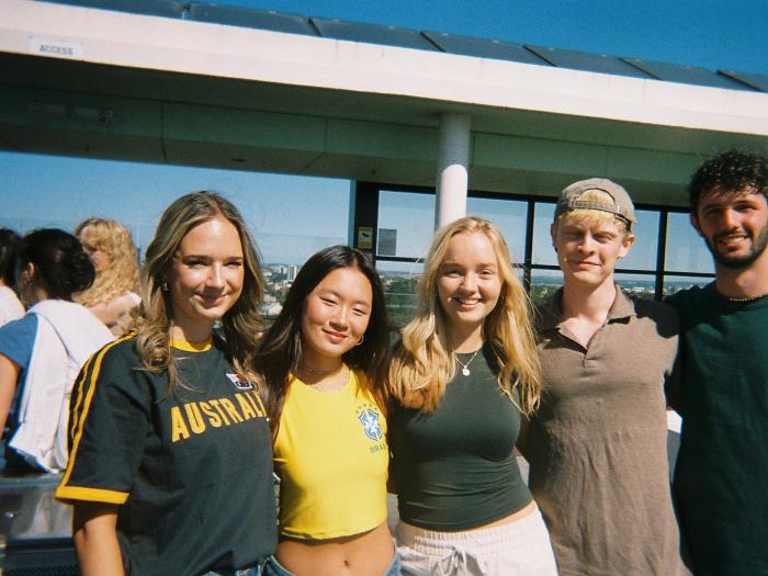 student posing with their friend group in Australia