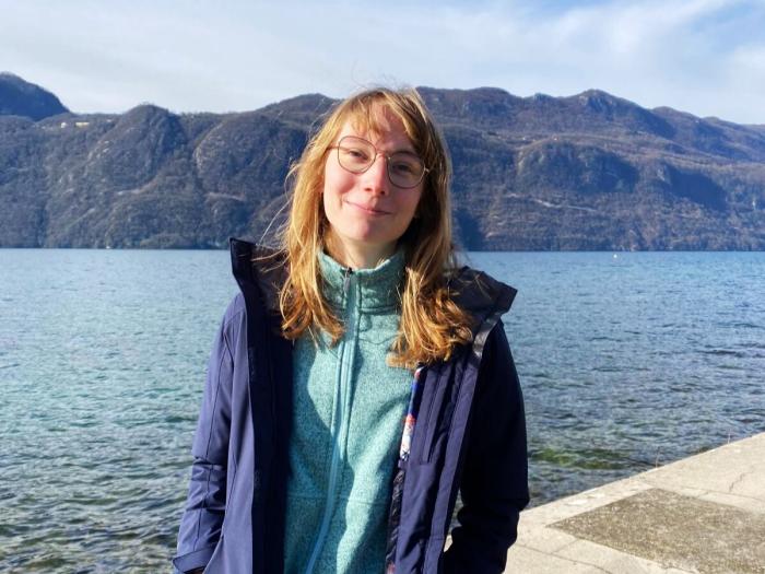 student with the lake in France view and mountain range on the background