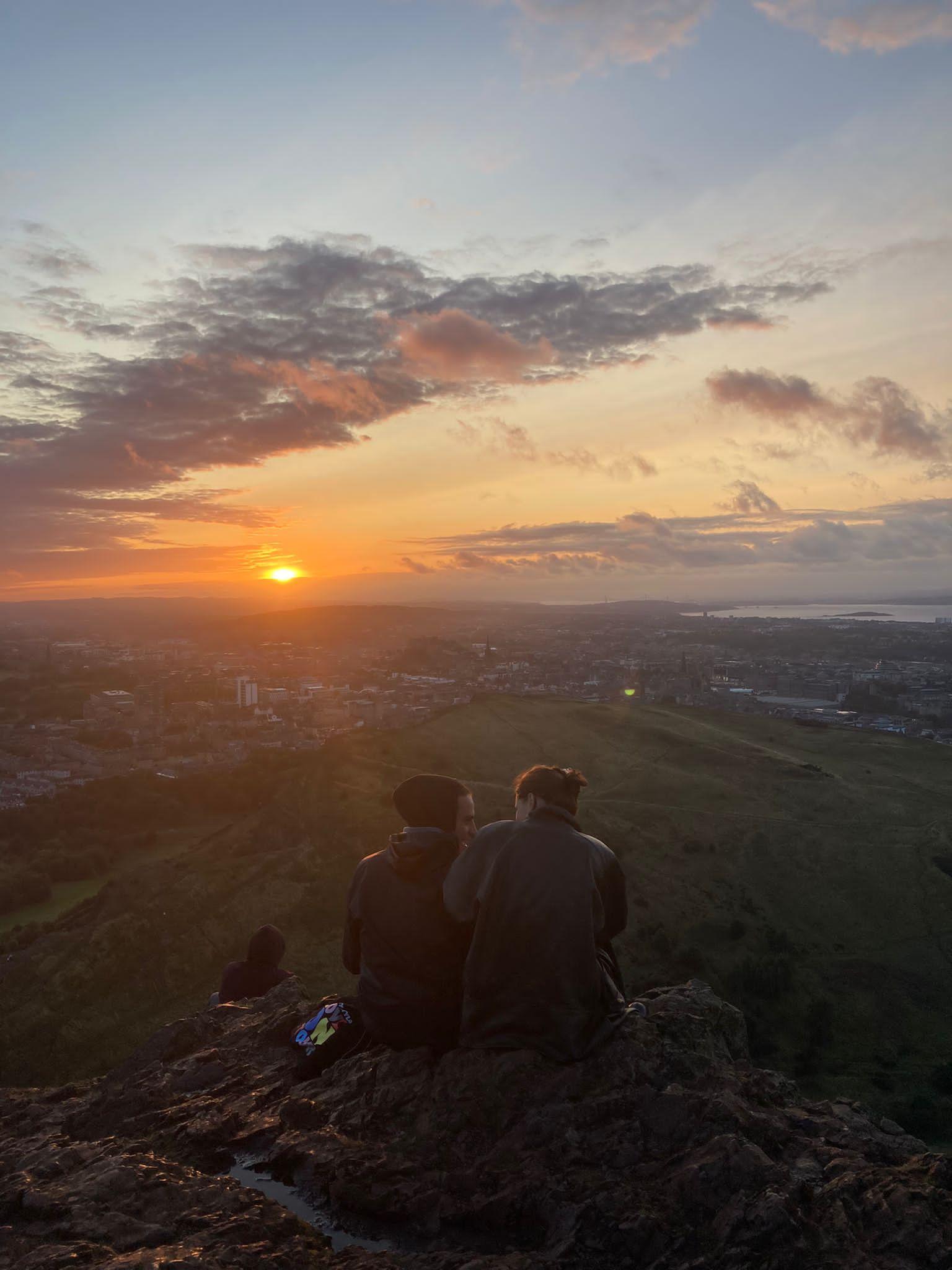 Flora Roy watching a sunset in Scotland