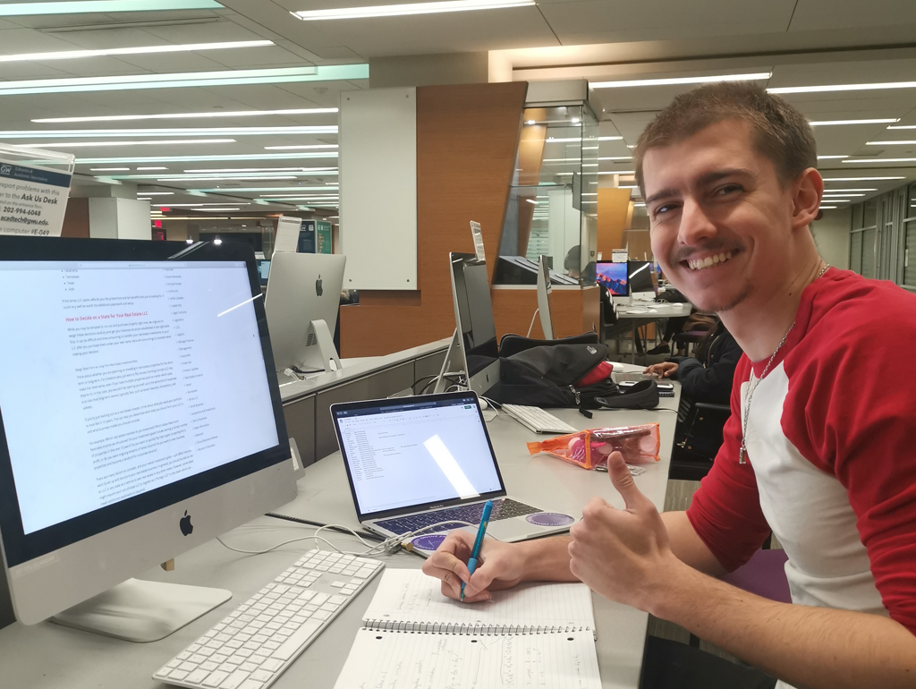 An exchange student working on a computer in the Gelman Library.
